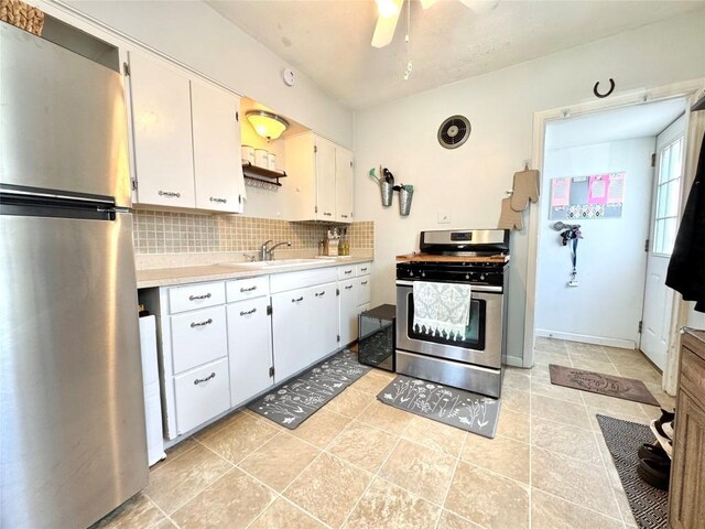 3524 French St, Erie, PA 16504 - kitchen featuring appliances with stainless steel finishes, light countertops, backsplash, a ceiling fan, and white cabinetry