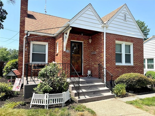 3524 French St, Erie, PA 16504 - view of front of house with brick siding, a chimney, and a shingled roof