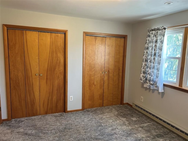 6848 6th Hwy, Linesville, PA 16424 - bedroom featuring a baseboard heating unit, multiple closets, and carpet flooring