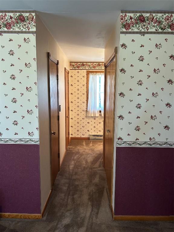 6848 6th Hwy, Linesville, PA 16424 - hall with a baseboard heating unit, wallpapered walls, and dark colored carpet