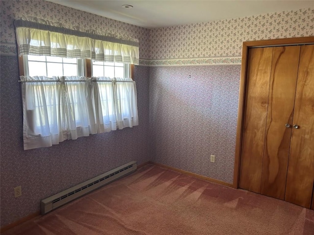 6848 6th Hwy, Linesville, PA 16424 - unfurnished bedroom with a baseboard heating unit, wallpapered walls, a closet, and carpet flooring