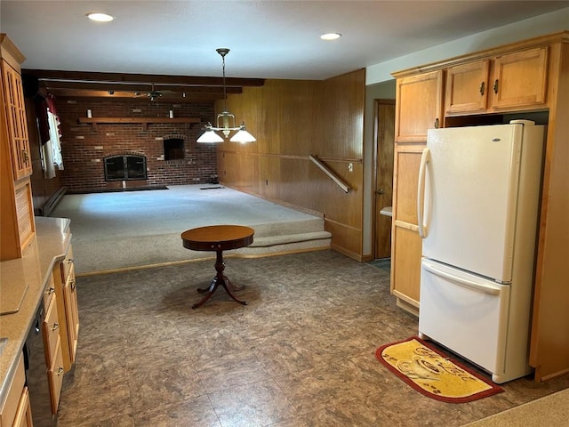 6848 6th Hwy, Linesville, PA 16424 - kitchen featuring light countertops, freestanding refrigerator, pendant lighting, wooden walls, and a fireplace