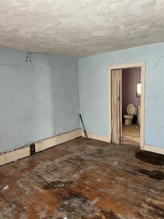 unfurnished room featuring dark hardwood / wood-style floors