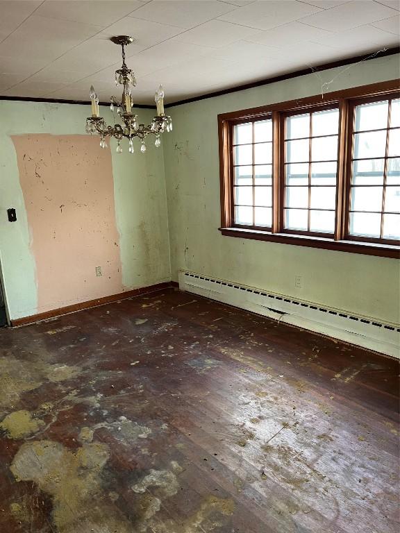 unfurnished dining area with a notable chandelier and a baseboard radiator