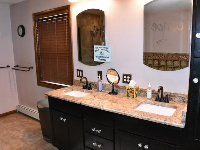 bathroom featuring double vanity, a sink, baseboards, and a baseboard radiator