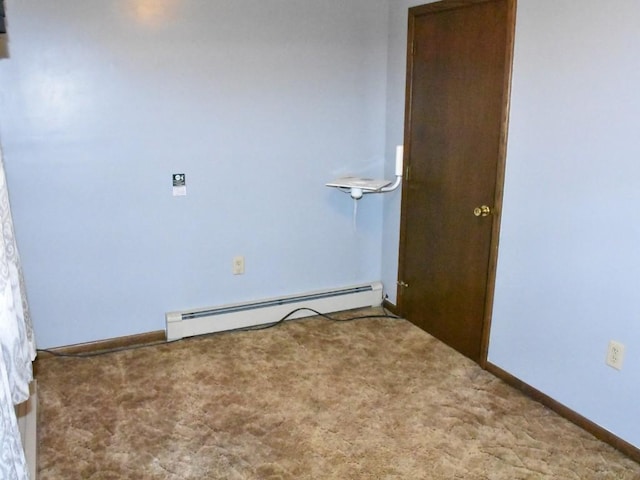 carpeted spare room featuring baseboards and a baseboard radiator