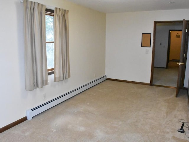 carpeted spare room featuring baseboards and a baseboard radiator