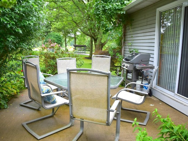 view of patio / terrace with a grill and outdoor dining area