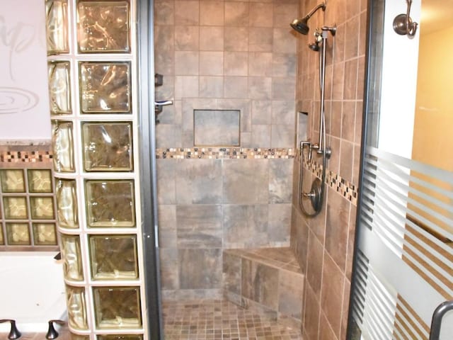 full bathroom featuring a garden tub and tiled shower