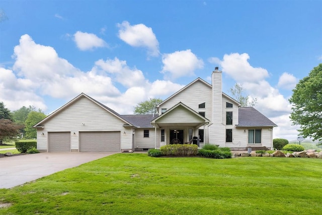 10170 Tiger Lily Ln, Waterford, PA 16441 - traditional-style house featuring concrete driveway, a front lawn, an attached garage, a chimney, and roof with shingles