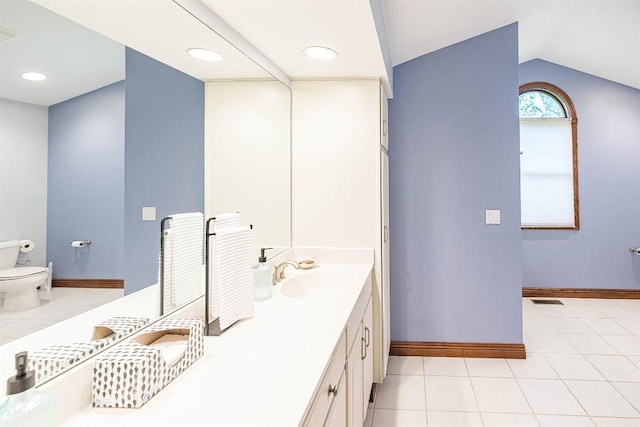 10170 Tiger Lily Ln, Waterford, PA 16441 - bathroom featuring toilet, double vanity, lofted ceiling, tile patterned flooring, and baseboards