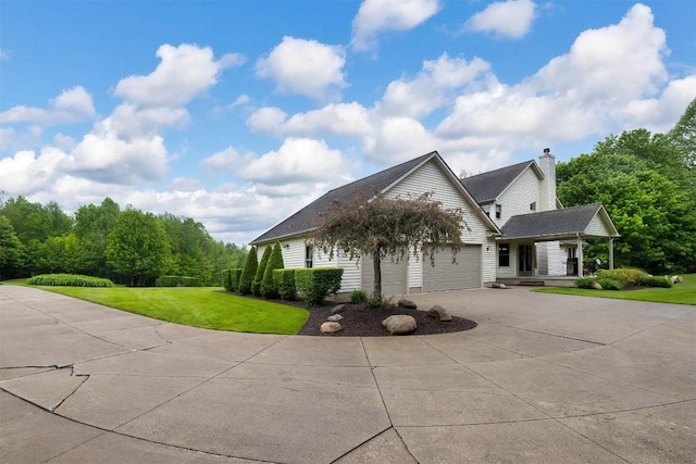 10170 Tiger Lily Ln, Waterford, PA 16441 - view of front of property with driveway, a front lawn, an attached garage, and a porch