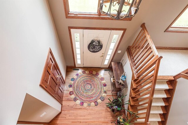 10170 Tiger Lily Ln, Waterford, PA 16441 - entrance foyer featuring stairway, a chandelier, a high ceiling, wood finished floors, and baseboards