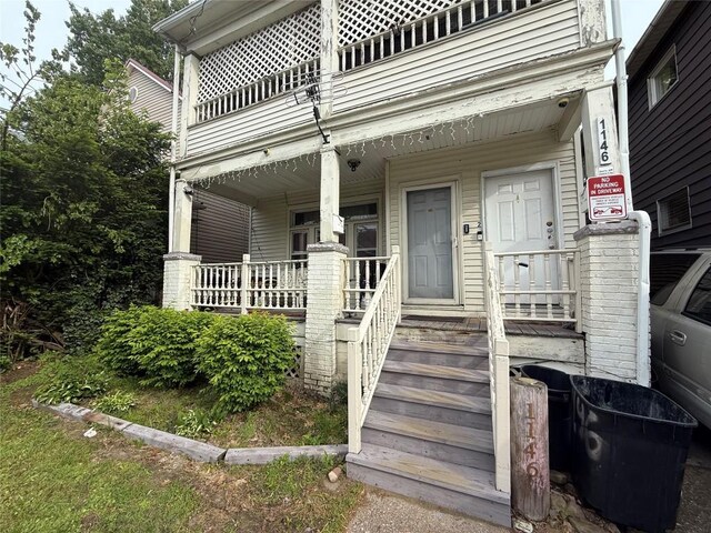 1146 W 5th St, Erie, PA 16502 - property entrance featuring a porch and a balcony