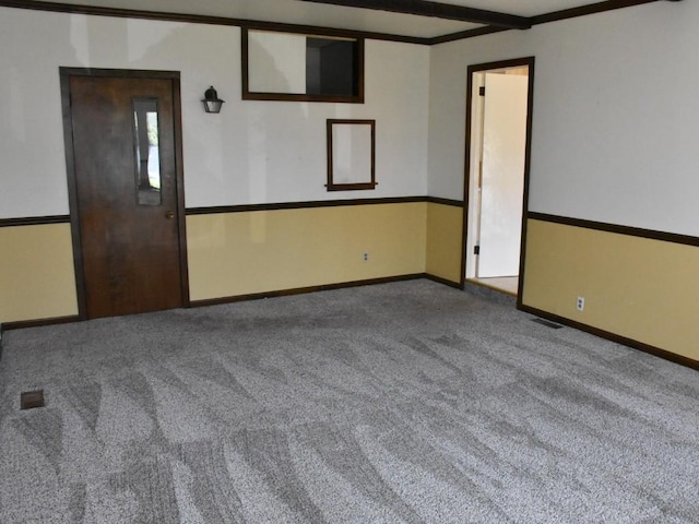 unfurnished room with baseboards, ornamental molding, and carpet