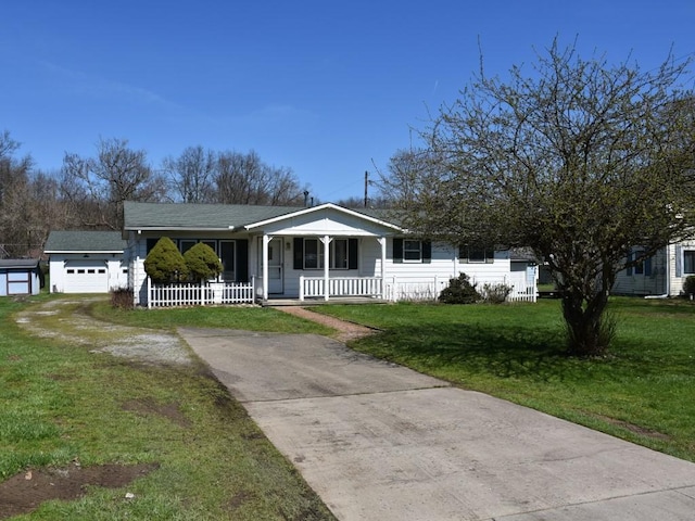 bungalow featuring concrete driveway, a garage, a front yard, and covered porch