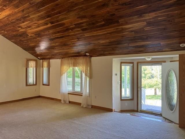 interior space with carpet, lofted ceiling, and wooden ceiling