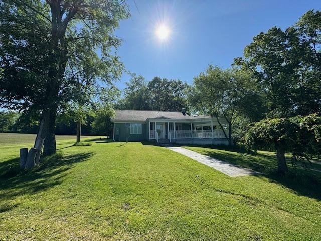 view of front of house featuring covered porch and a front lawn