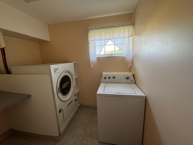 washroom with washer and dryer and light tile patterned flooring