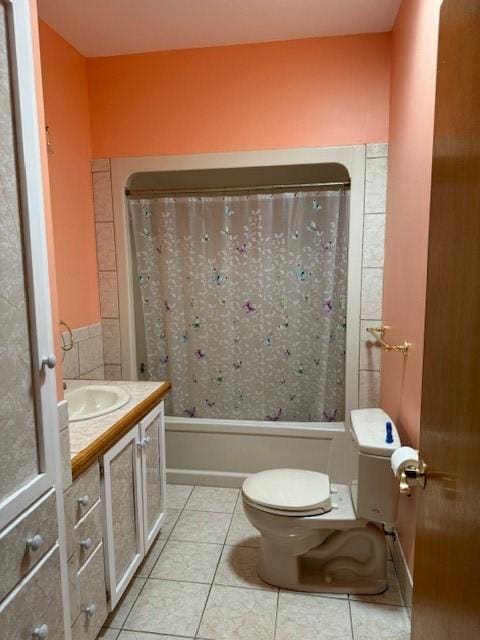 bathroom with toilet, vanity, and tile patterned floors