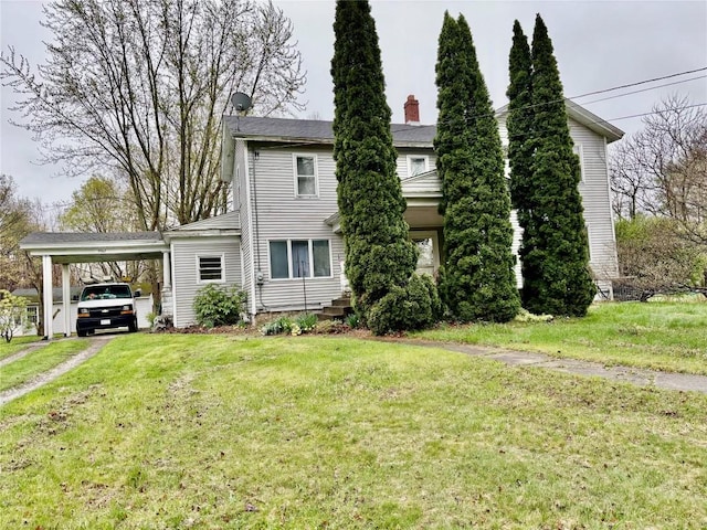 9967 Smith St, Lake City Borough, PA 16423 - view of front of house with driveway, a chimney, a front yard, and an attached carport
