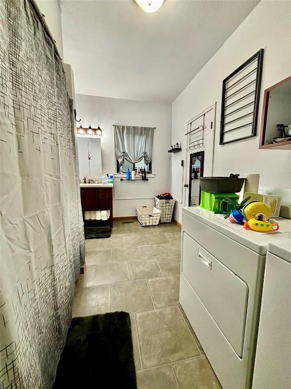 9967 Smith St, Lake City Borough, PA 16423 - bathroom featuring washing machine and dryer and vanity