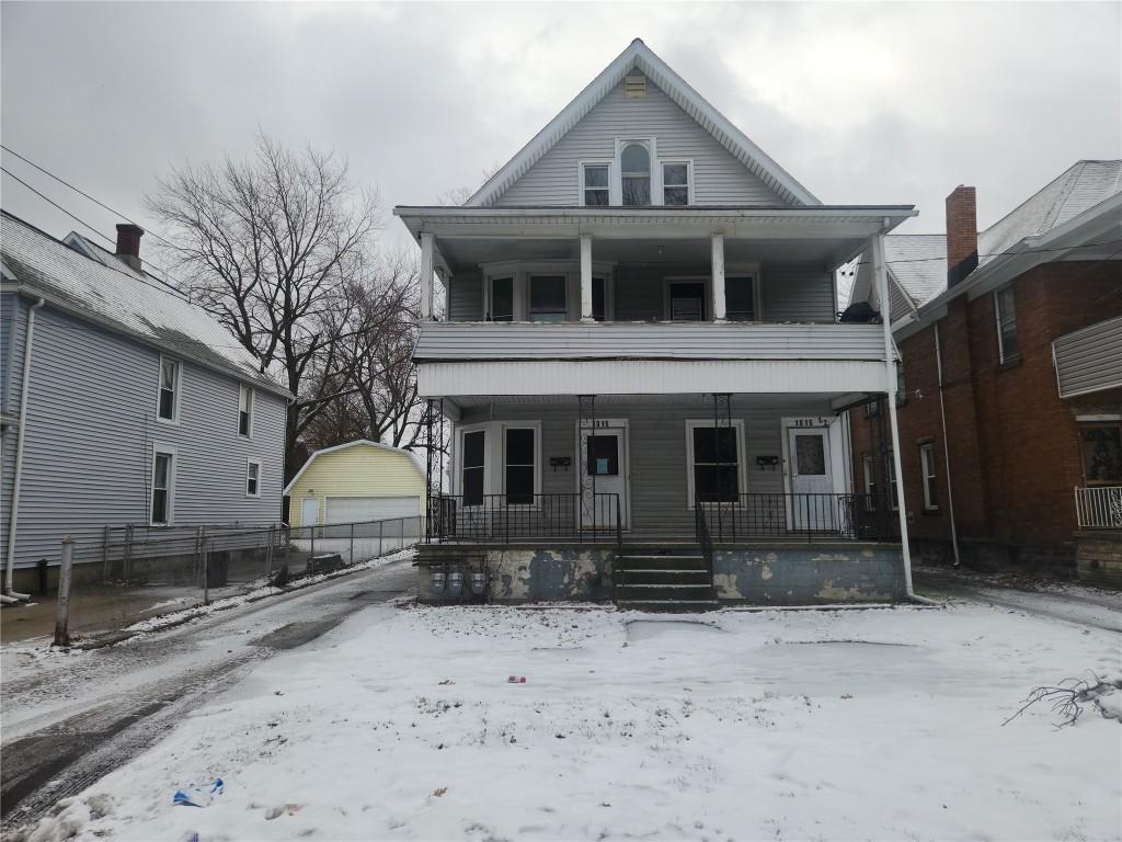 view of front facade featuring an outbuilding and a garage