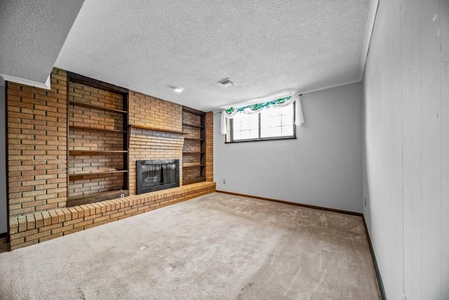 unfurnished living room with a textured ceiling, carpet, and a fireplace