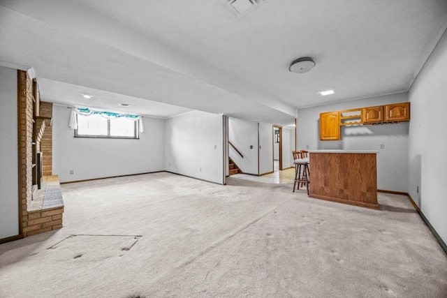 basement featuring bar and light carpet