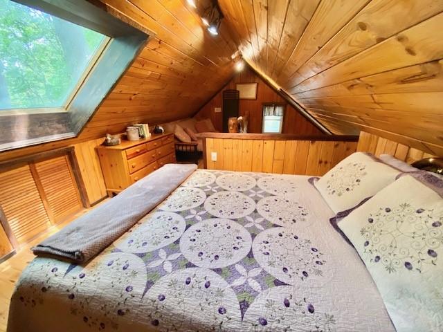 10634 N Edgewood Dr, Lake City Borough, PA 16423 - bedroom featuring wooden ceiling, wood walls, and lofted ceiling