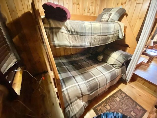 10634 N Edgewood Dr, Lake City Borough, PA 16423 - bedroom with wooden walls and wood finished floors