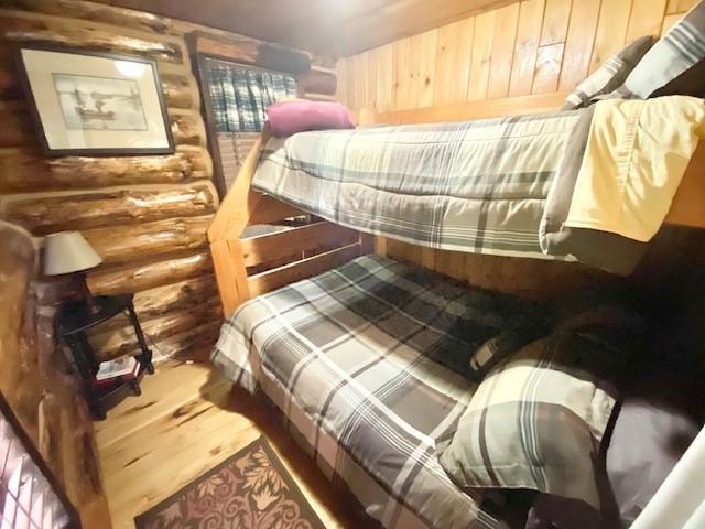 10634 N Edgewood Dr, Lake City Borough, PA 16423 - bedroom with rustic walls and wood finished floors