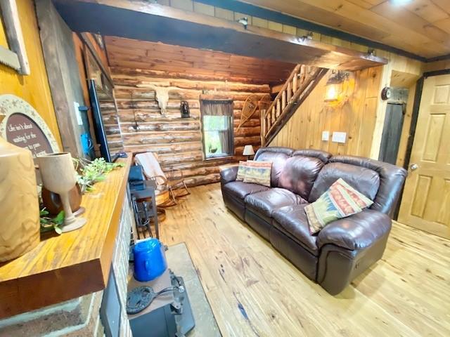 10634 N Edgewood Dr, Lake City Borough, PA 16423 - living room featuring rustic walls, wood-type flooring, stairway, wood ceiling, and wooden walls