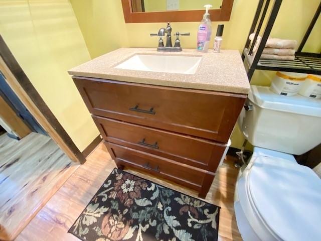 10634 N Edgewood Dr, Lake City Borough, PA 16423 - bathroom with toilet, vanity, and wood finished floors