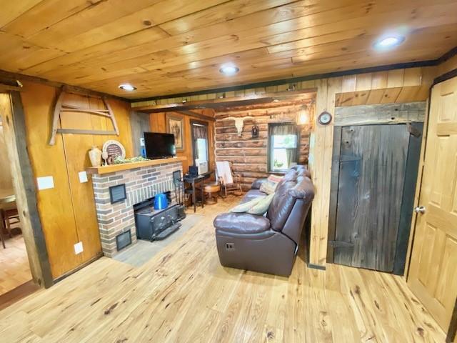 10634 N Edgewood Dr, Lake City Borough, PA 16423 - living area with wood ceiling, hardwood / wood-style floors, a fireplace, rustic walls, and wooden walls