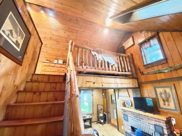 10634 N Edgewood Dr, Lake City Borough, PA 16423 - stairs featuring wooden walls, wooden ceiling, healthy amount of natural light, a fireplace, and high vaulted ceiling