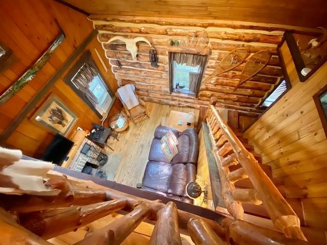 10634 N Edgewood Dr, Lake City Borough, PA 16423 - living area with hardwood / wood-style floors, log walls, and wood ceiling