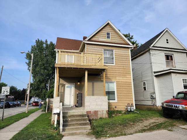 view of front of house featuring a balcony