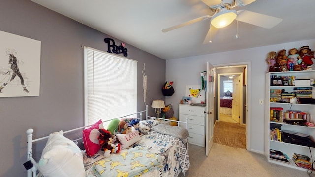 bedroom featuring ceiling fan and light carpet