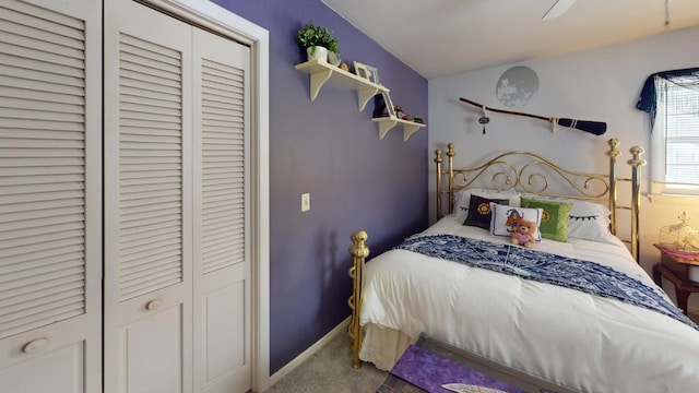 bedroom with ceiling fan, a closet, and light carpet