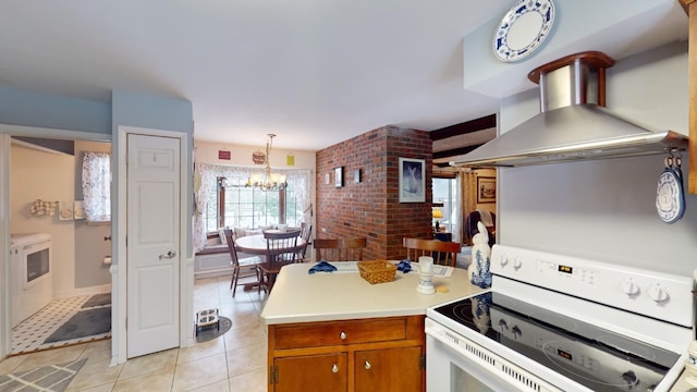 kitchen featuring wall chimney exhaust hood, decorative light fixtures, an inviting chandelier, white electric range, and light tile patterned flooring