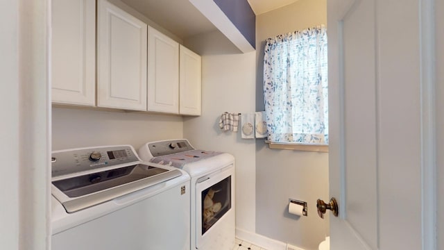 laundry room with cabinets, separate washer and dryer, and light tile patterned floors