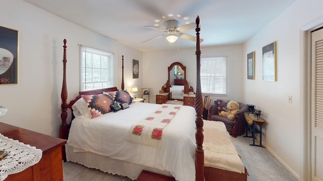 carpeted bedroom featuring multiple windows and ceiling fan