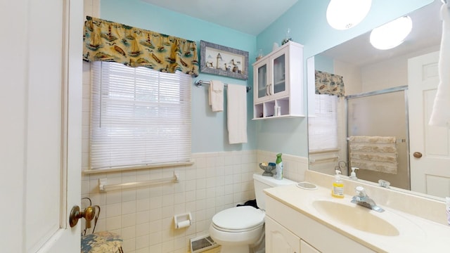 bathroom featuring vanity, toilet, and tile walls