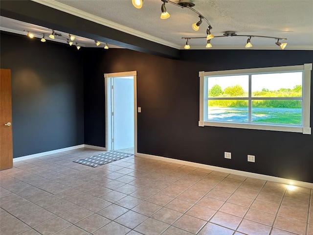 spare room featuring ornamental molding, a textured ceiling, and light tile patterned floors