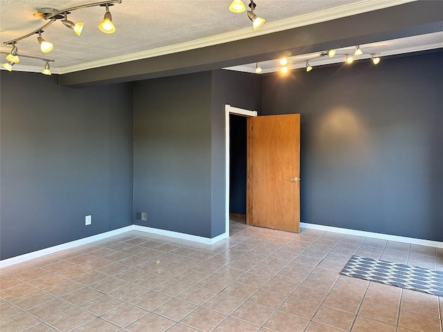 tiled spare room featuring ornamental molding and a textured ceiling