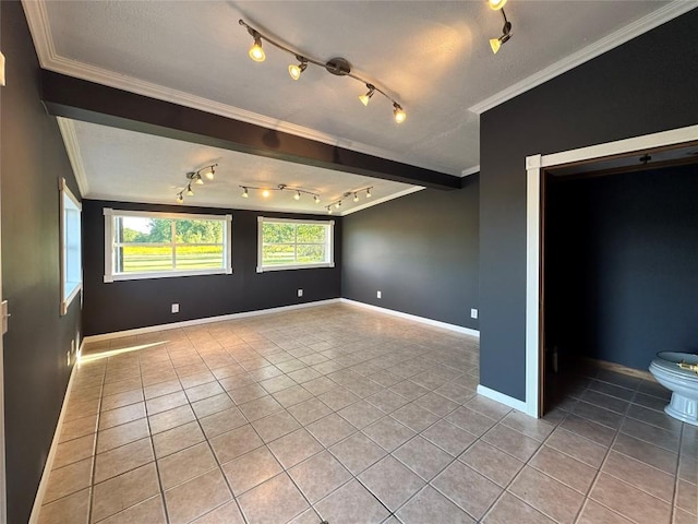 spare room featuring light tile patterned floors and ornamental molding