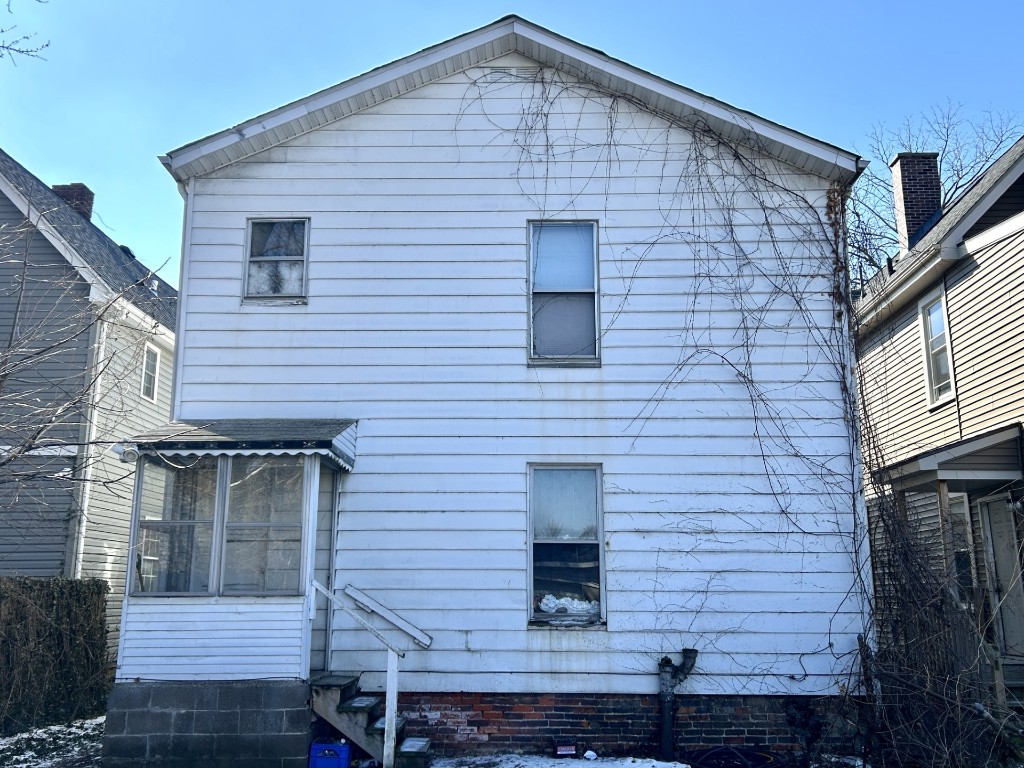 view of side of home featuring entry steps