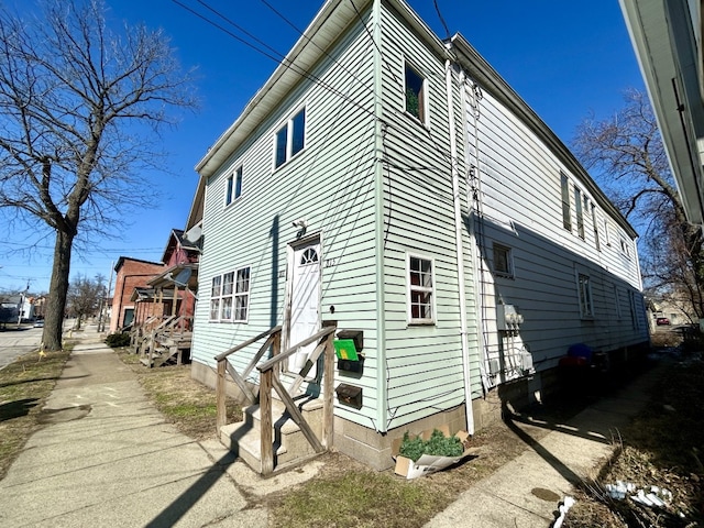 view of side of property featuring entry steps