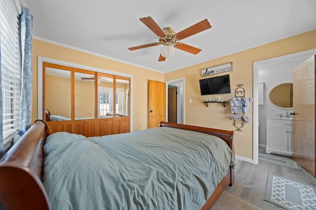 5243 W 53rd St, Fairview, PA 16415 - bedroom featuring wood finished floors, ornamental molding, ceiling fan, ensuite bath, and a closet